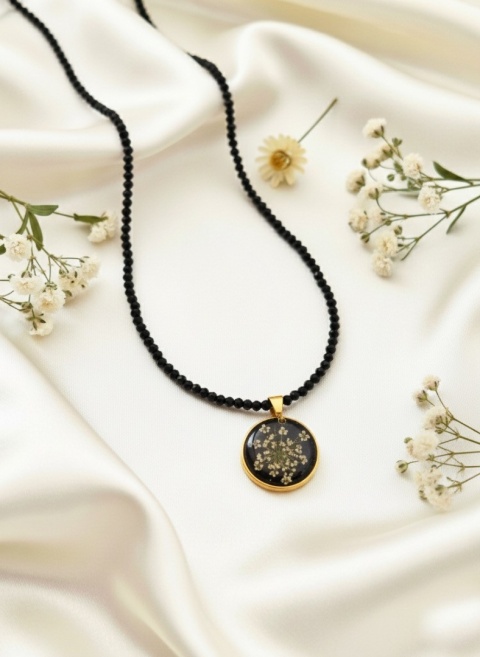 naszyjnik z kwiatami na satynowej tkaninie